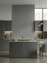 White linen fluted WPC panels forming a tall kitchen accent wall above the island cooktop