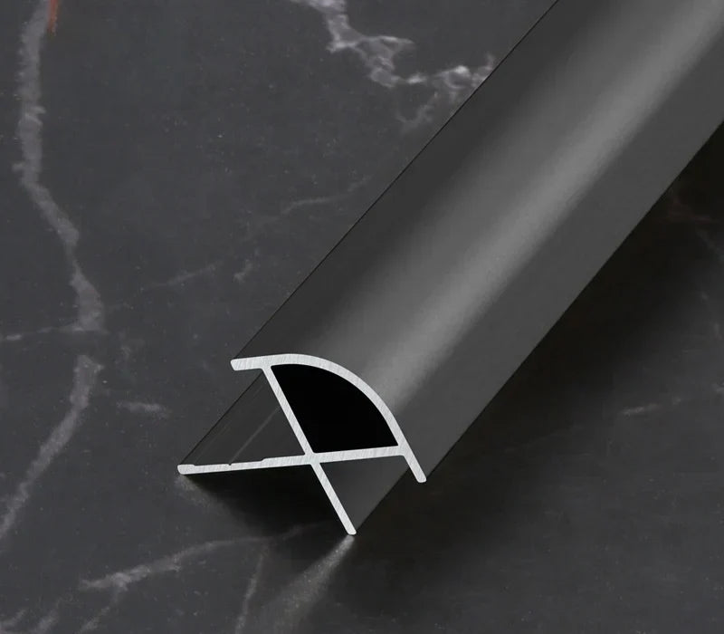 Black curved aluminum wall panel trim sample with its cross-section visible