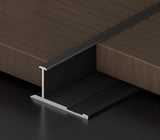 Black 3mm aluminum H-joint connection trim positioned between dark wood-look PVC wall panels