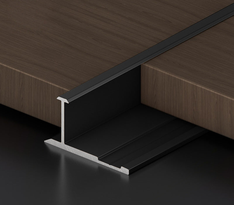 Black 3mm aluminum H-joint connection trim positioned between dark wood-look PVC wall panels