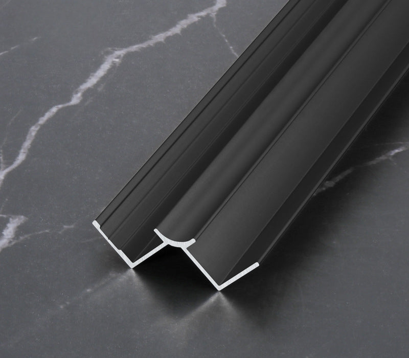 Black 3mm aluminum inside corner trim profile close-up on dark marble