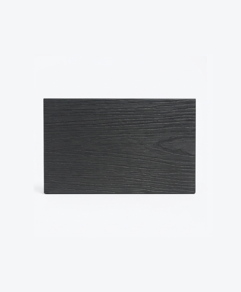 Black composite fence sample with horizontal wood-grain texture