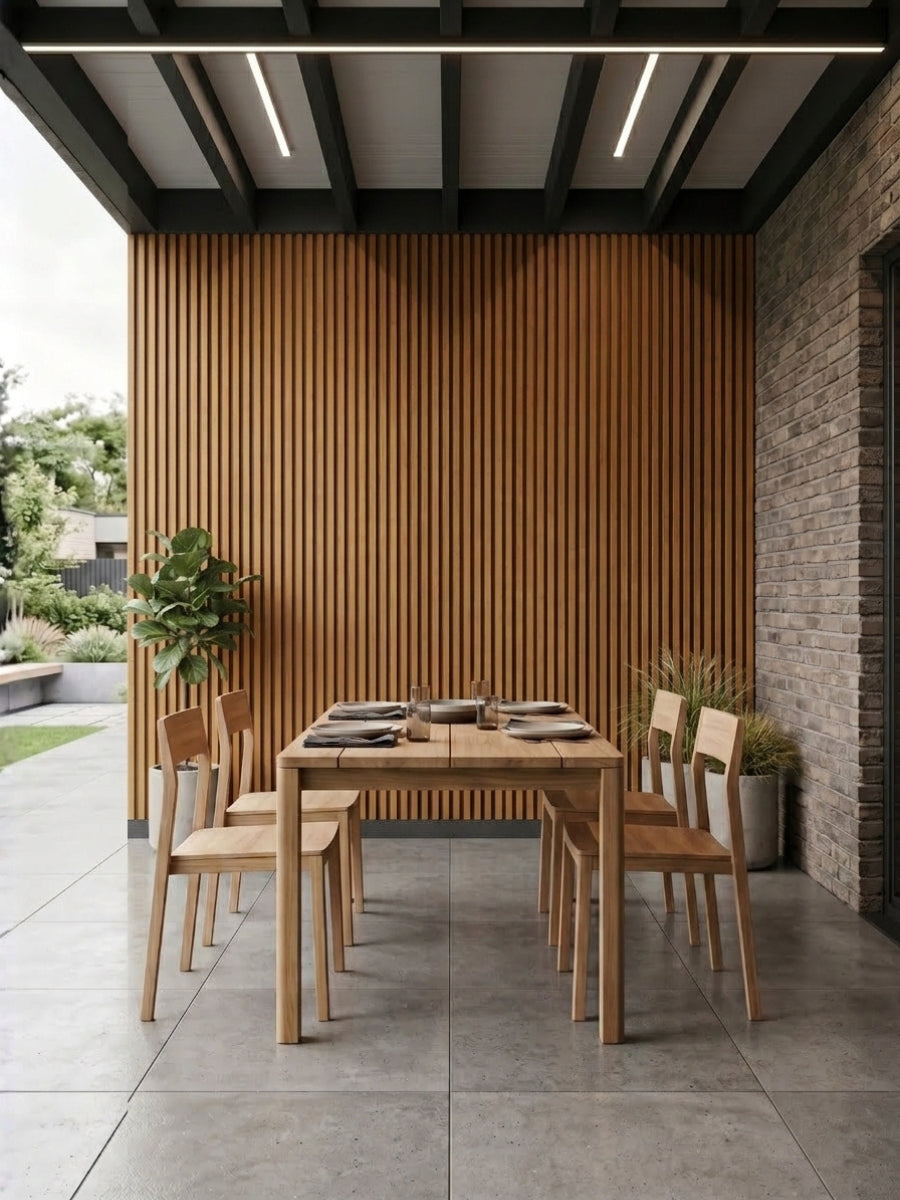 Brown and black composite exterior cladding installed as a vertical slat wall in a covered outdoor dining area