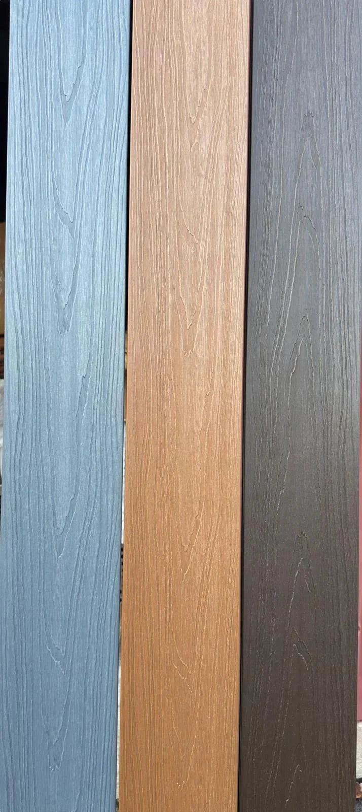 Light gray co-extruded composite decking with wood grain texture