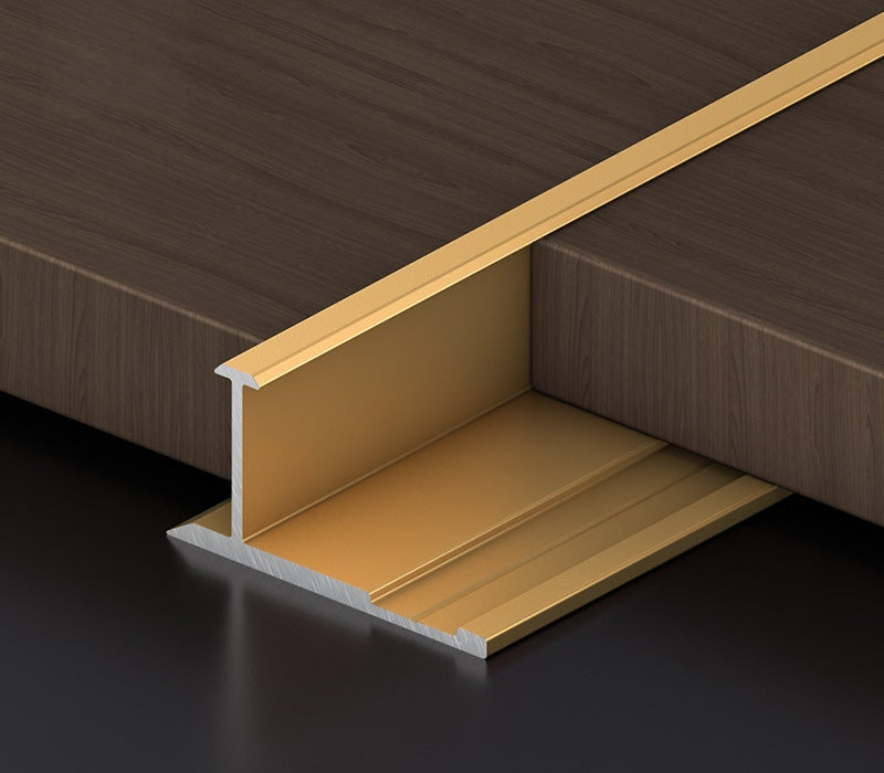 Gold 3mm aluminum H-joint connection trim positioned between dark wood-look PVC wall panels