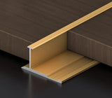 Gold I-shaped aluminum wall panel trim sample positioned between wood-look panels
