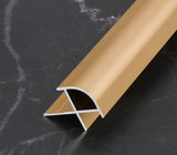 Gold 3mm aluminum outside corner trim with rounded face and exposed cross-section