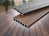 Light silver composite decking board with wood grain texture