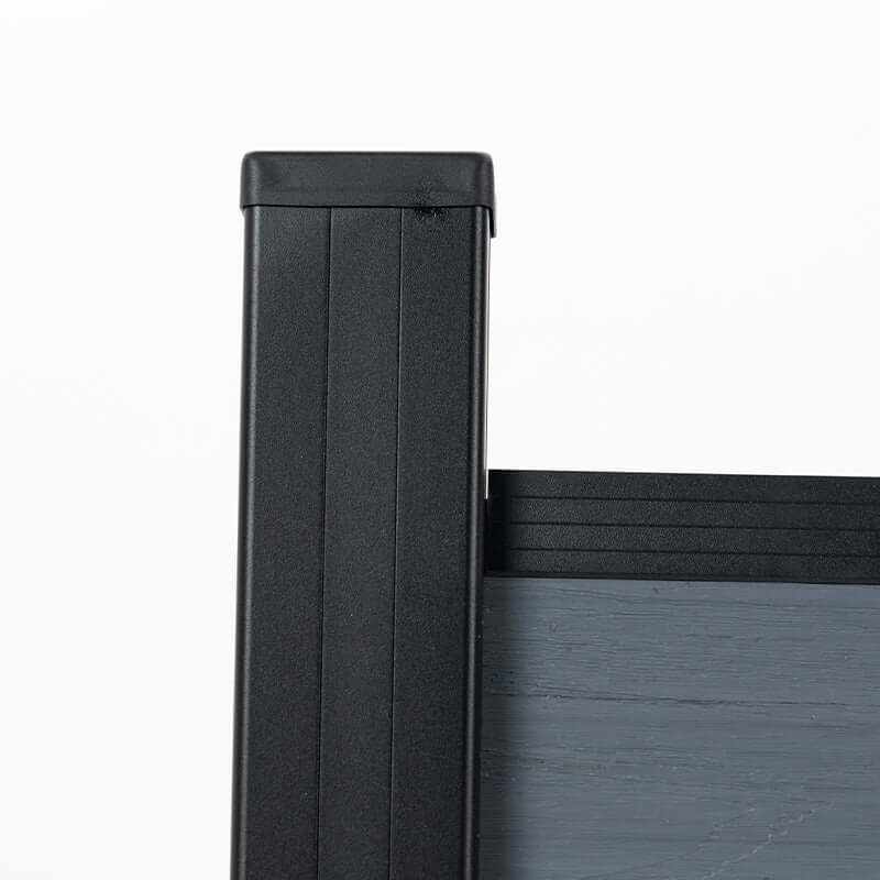 Close-up of a capped black post and top rail on the light gray composite fence