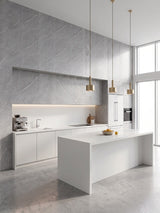 Ash gray marble PVC wall panels installed in a modern white kitchen with an island and pendant lights