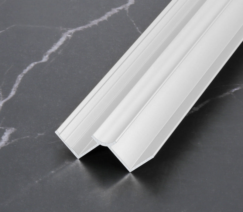 White 3mm aluminum inside corner trim profile close-up on dark marble