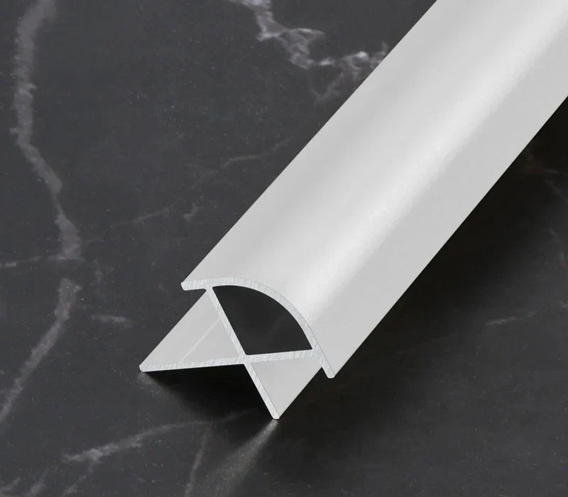 White curved aluminum wall panel trim sample with its cross-section visible