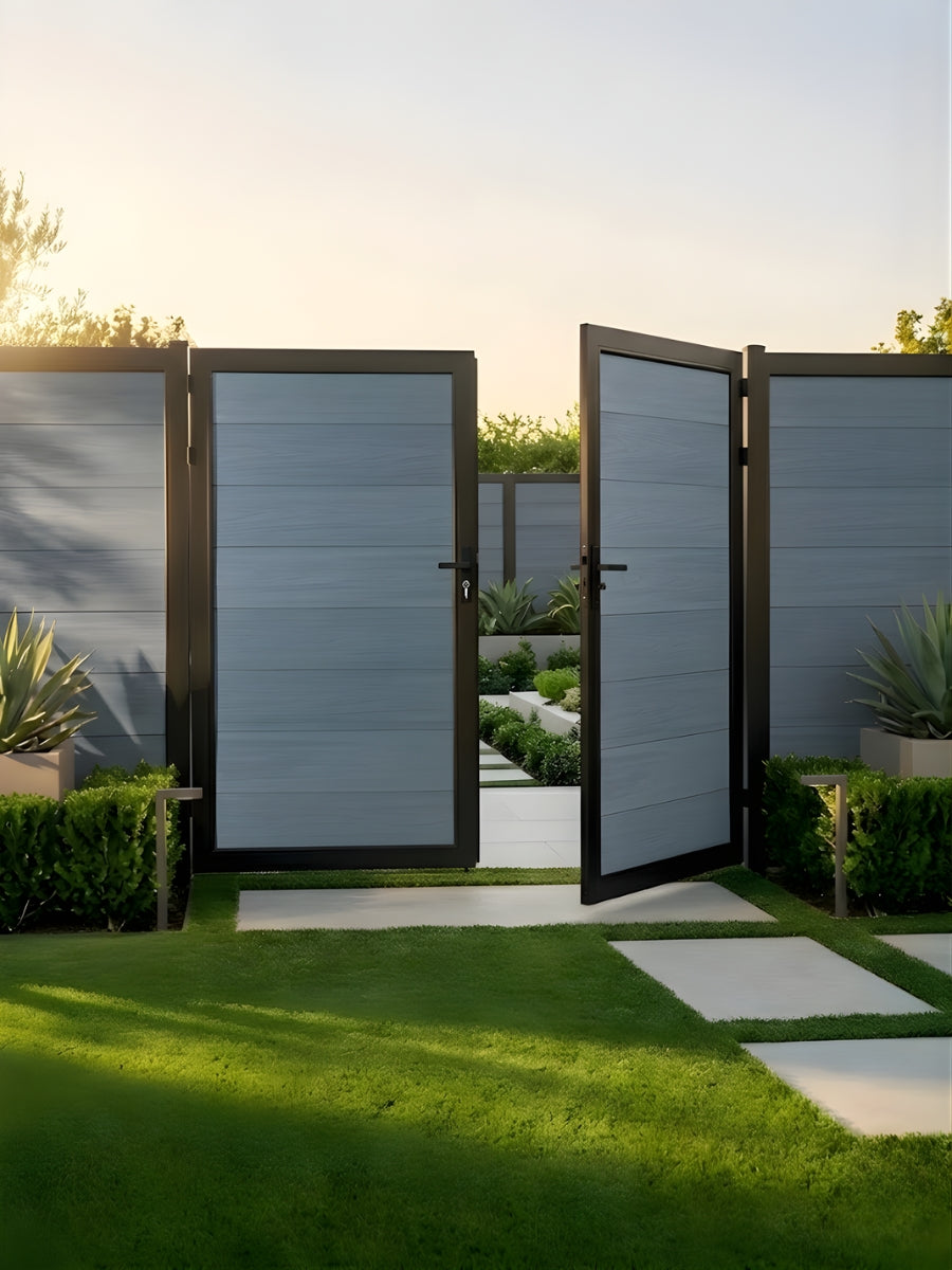 Light gray WPC double fence gate partially open beside a landscaped lawn and pathway