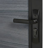 Close-up of black lever handle and keyed lock on light gray WPC fence gate