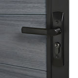 Close-up of the black lever handle and keyed lock on a gray WPC fence gate