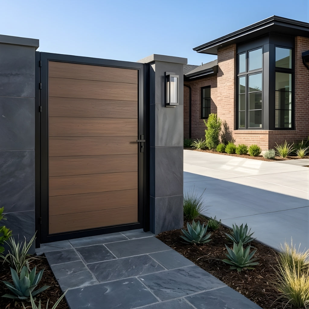 Brown WPC fence single gate installed between stone pillars at a modern home entrance