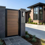 Brown WPC fence gate installed between masonry pillars at a modern home entrance