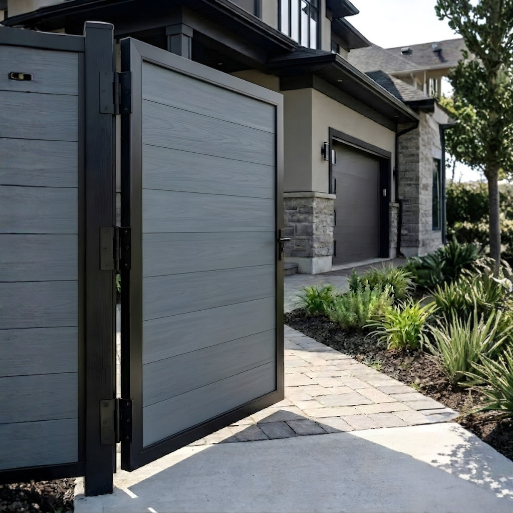Open gray WPC fence single gate beside a landscaped residential walkway