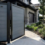 Open gray WPC fence single gate beside a landscaped residential walkway