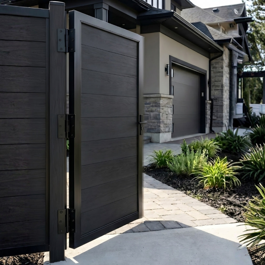 Open black WPC fence gate showing hinges beside a landscaped residential path