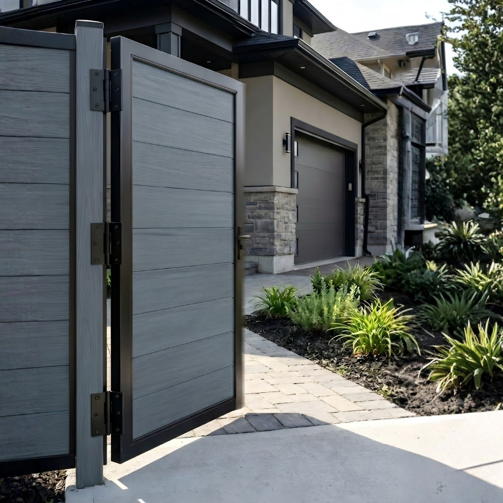 Open light gray WPC fence gate showing black hinges beside a landscaped home walkway